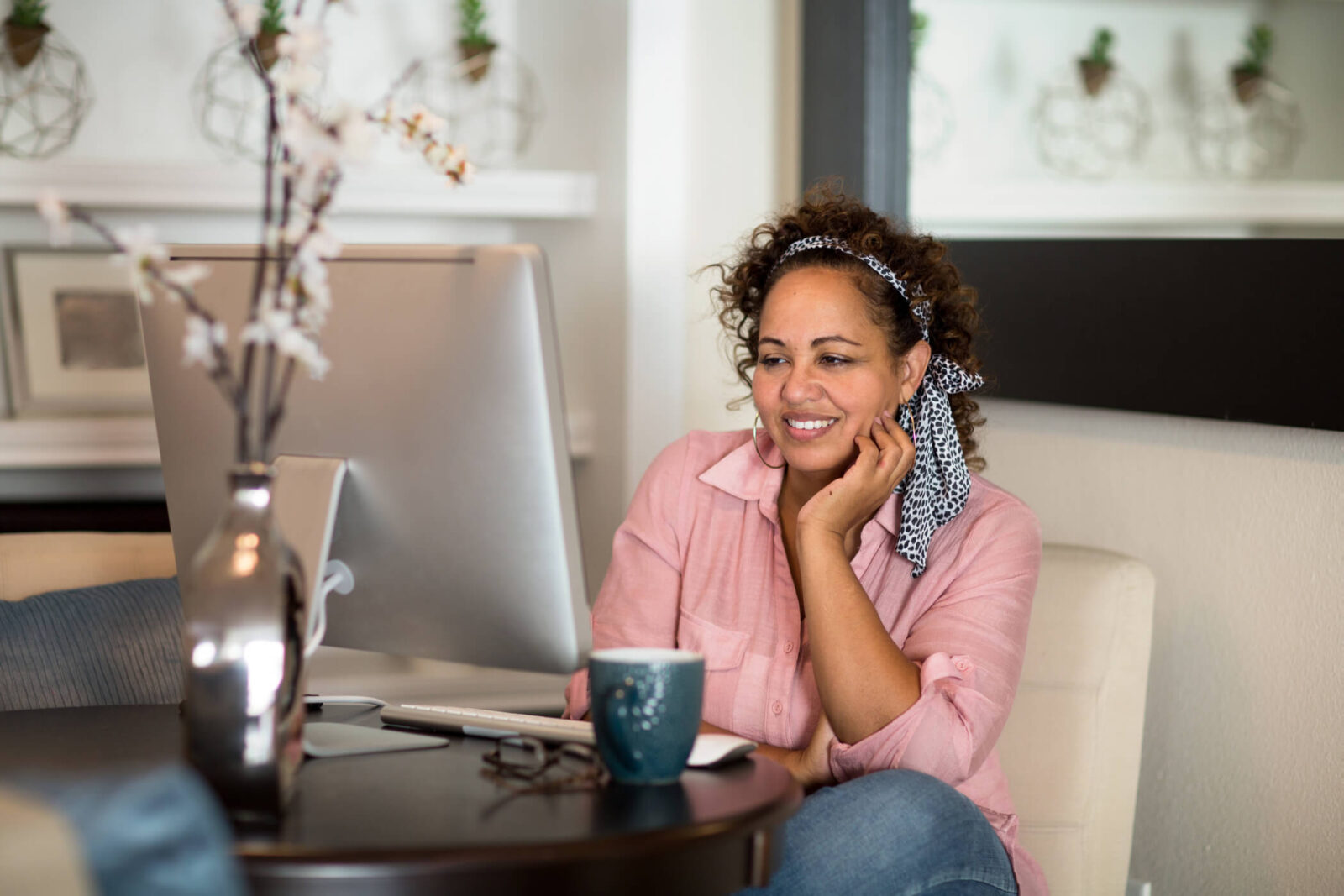 Happy woman working from her home office.